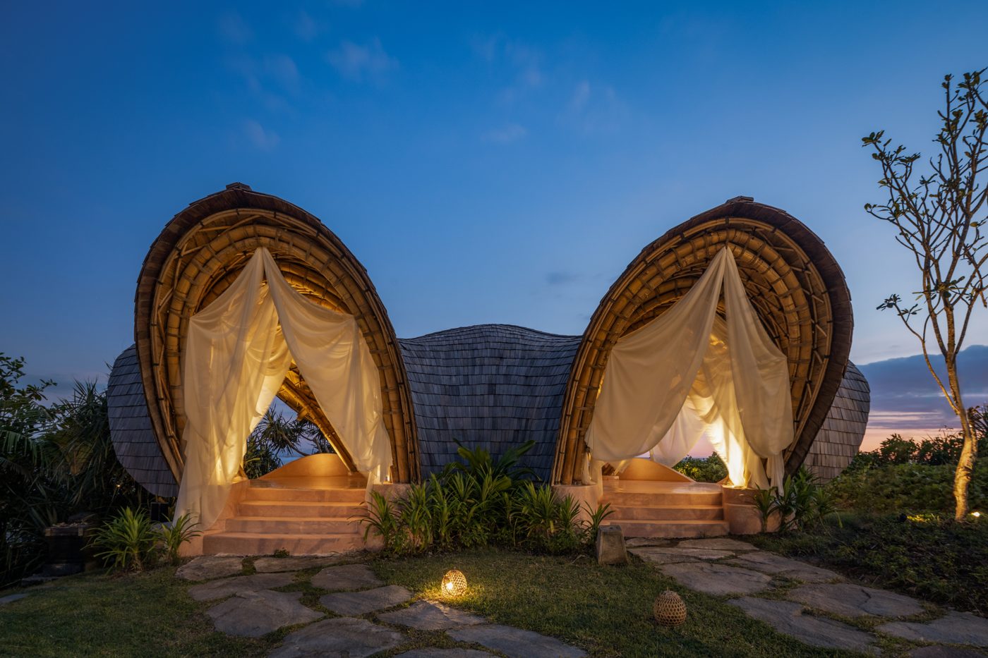 Bamboo cocoon nests lit up at dusk