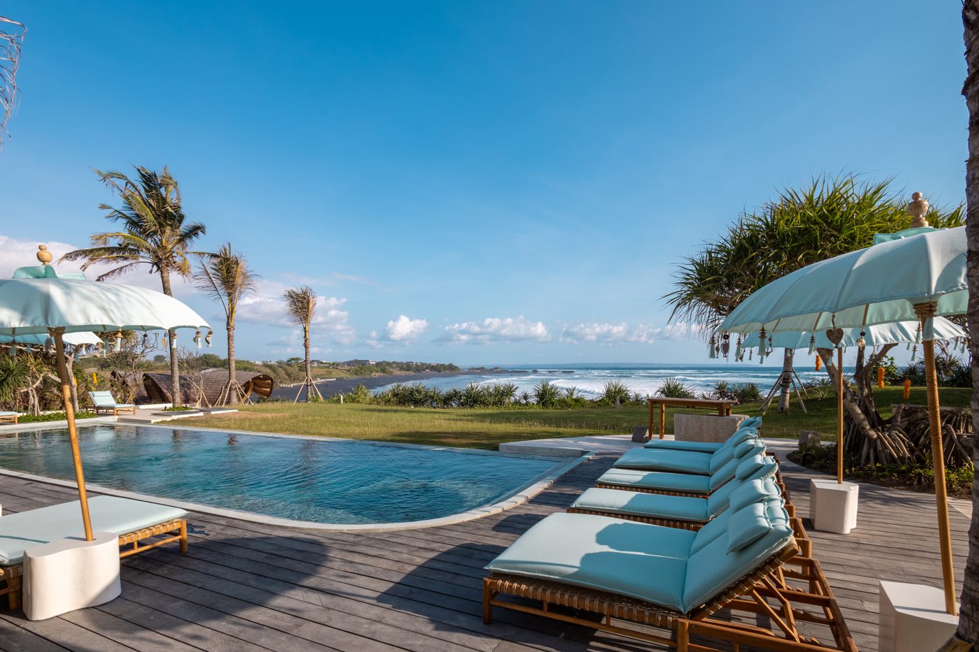 Pool deck with Balinese umbrellas overlooking the ocean